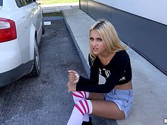 Scantily clad blonde beauty sucks a cock in the car