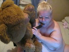Fat blonde granny fucks a teddy-bear in webcam solo clip