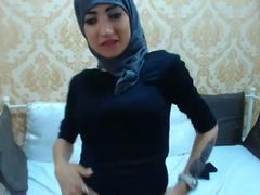 Gal in hijab and legging rubs her butt with a big dildo
