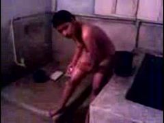 Cute and busty young Desi wife washes herself on home video