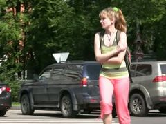 Slim girl pees in her legging while walking in the street